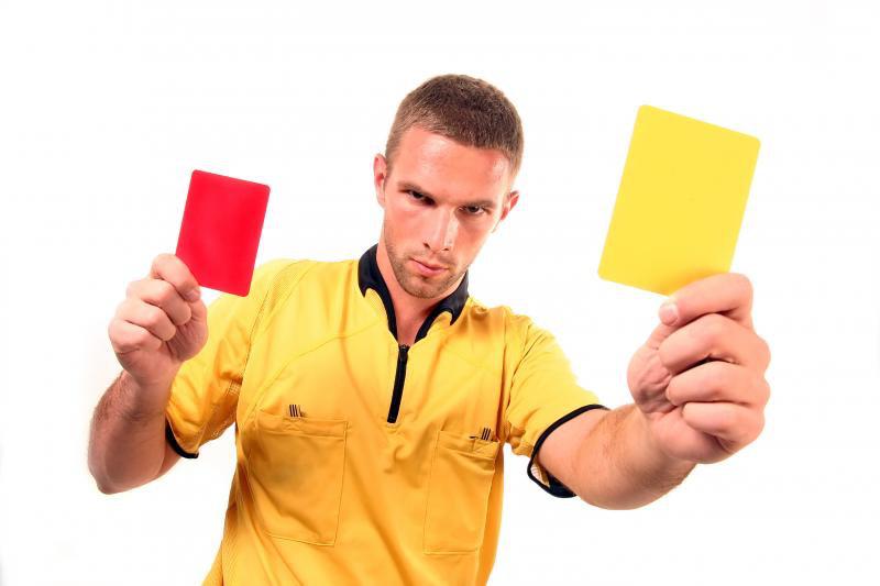 a football judge with yellow and red card